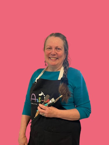 Margaret in a apron holding a paintbrush