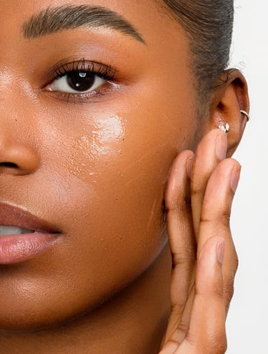 a model applies a skincare product in her face