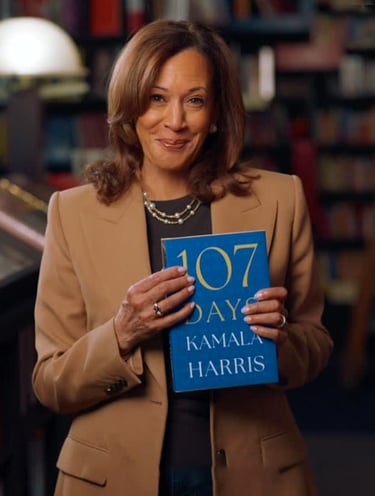 Smiling VP Kamala Harris holding her new book, 107 DAYS.