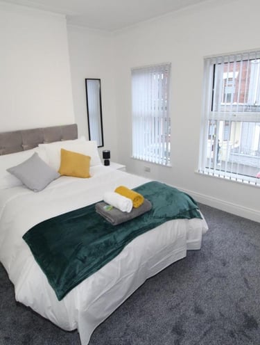 bedroom with bed and white walls