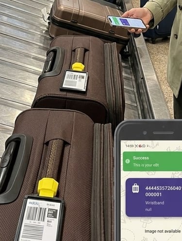 A lady at the baggage carousel checking her bag by scanning the eBt on the bag.