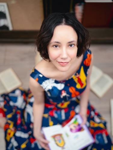 Maria is sitting on the floor with an open book on her lap