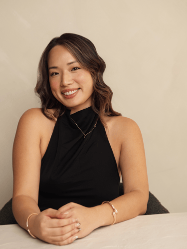 a woman in a black dress sitting at a table