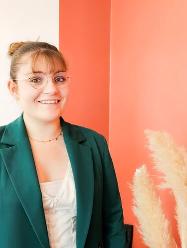 a woman in a green jacket and glasses