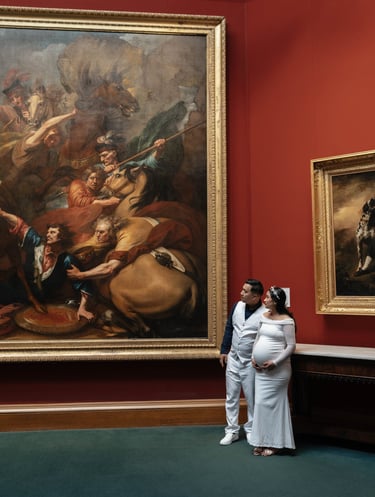 a man and woman standing in front of a painting