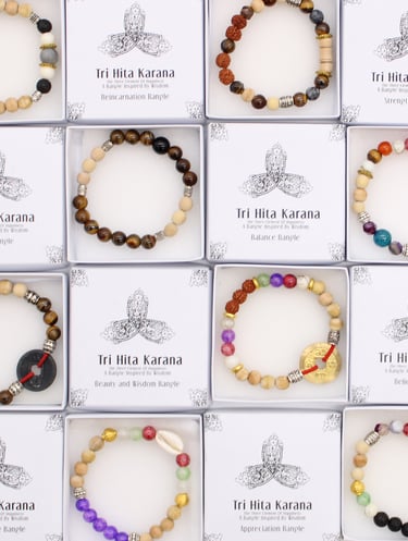 Handmade Tri Hita Karana beaded bracelets with natural gemstones and wood beads in white gift boxes.