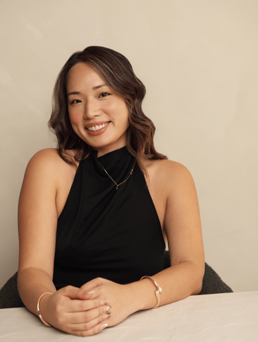 a woman in a black dress sitting at a table