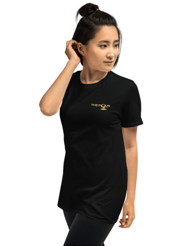 woman wearing the pour shop logo black t shirt walking view