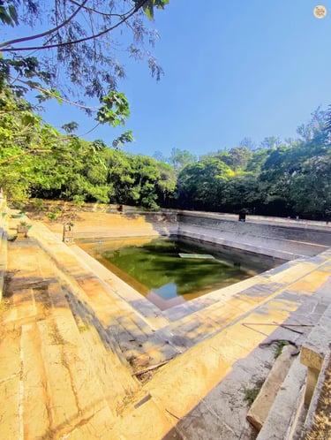 Amrita Sarovar, a symmetrical stepped pond at Nandi Hills, surrounded by stone steps and greenery