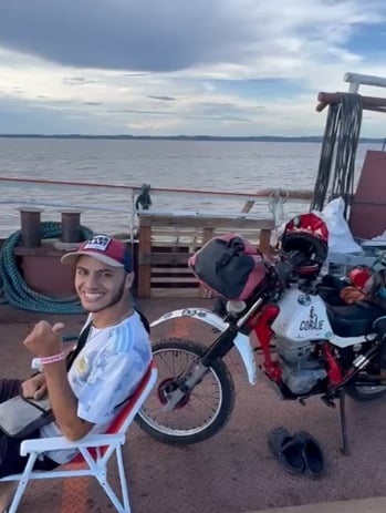 a man sitting in a chair with a helmet on