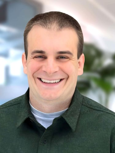 a man in a green shirt smiling at the camera