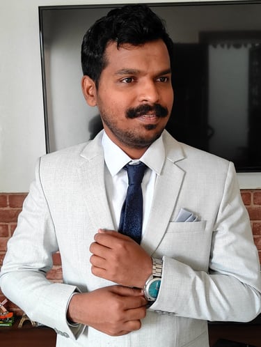 a man in a suit and tie is standing in front of a brick wall