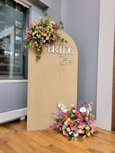 bridal shower backdrop in beige with spring flowers