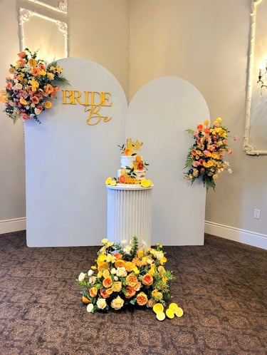 a bridal shower with a cake stand with a cake on top of it