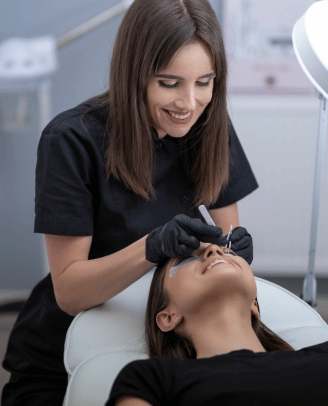 a woman getting her eyebrows done by a professional hairdresser