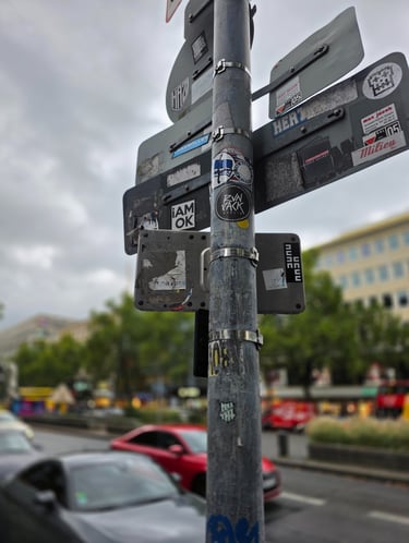 a street sign with stickers on it