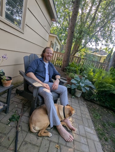 dog loves his pet sitter so much he snuggles at his feet on a patio
