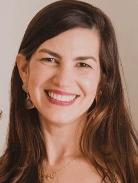 a woman with long hair and a gold necklace