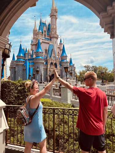 Kasey Kalk pictured with her husband in front of Cinderella Castle at Disney's Magic Kingdom®.