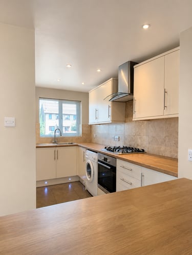 Bright kitchen with cream cabinets, wood countertops, gas hob, fitted in Littlemore
