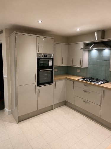 Modern kitchen with glossy grey cabinets, a built-in double oven, gas hob, fit in Kidlington