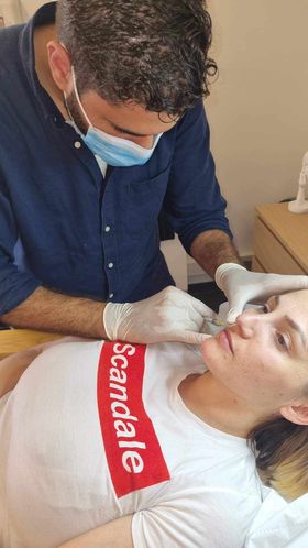 a man in a mask and gloves is getting a checkup