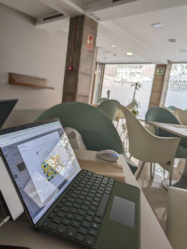 a laptop computer sitting on a table in a restaurant