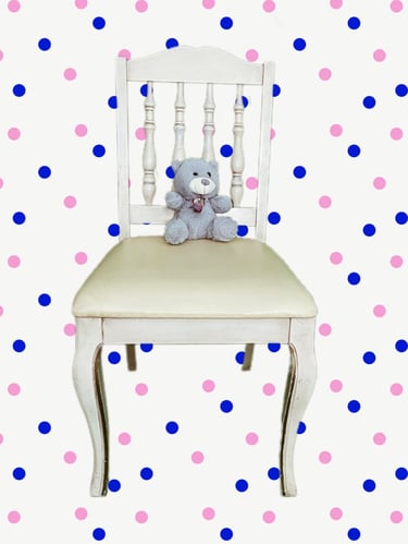 a teddy bear sitting on a chair with pink and blue polka dots wallpaper
