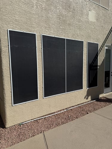 Installed black solar screens covering multiple windows