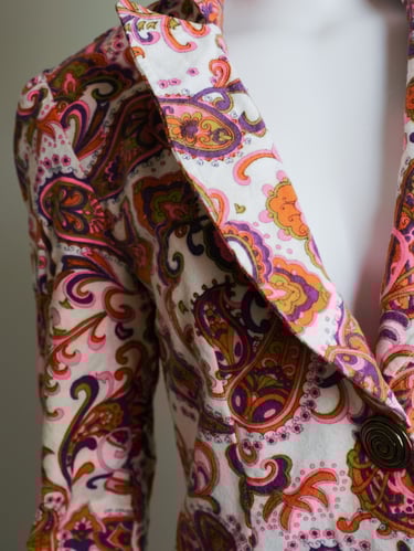 a woman's jacket with a colorful paisley pattern