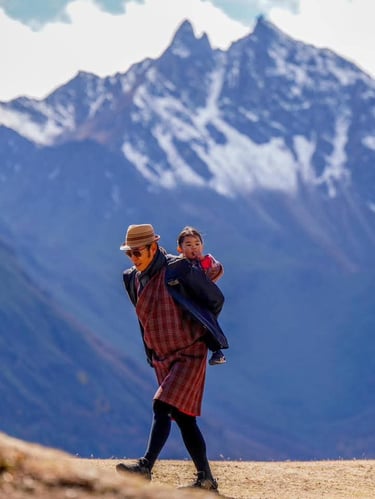 His-majesty-the-king-of-bhutan-with-princess-on-his-back-at-the-royal-highland-festival
