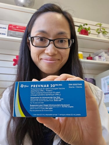 Pharmacist Linda Nghiem holding a prevnar 20 blue box