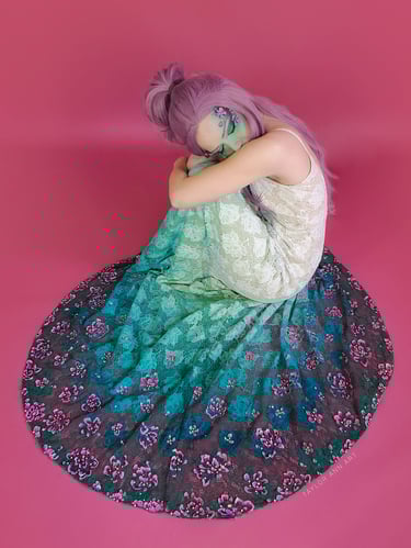Wedding Dress with a teal green dip dye and 3-d painted pink flowers around the hem on a model