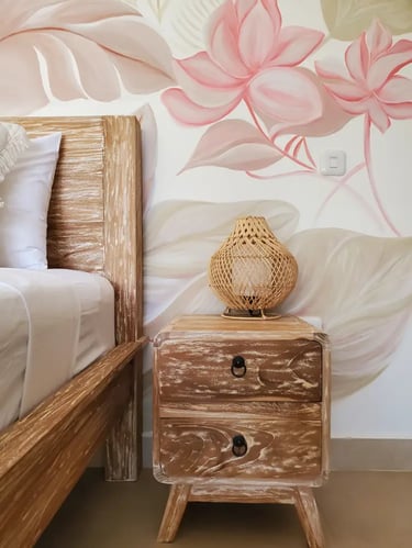 Elegant bedroom in a villa in Bali: wooden bed, floral fresco, quality construction