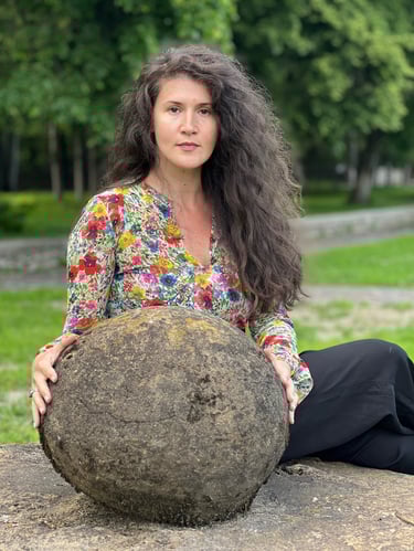 Facilitator holding a heavy stone as a metaphor for chronic constipation & emotional release