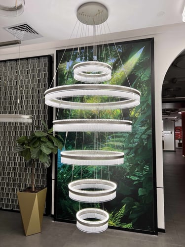 a large white circular light fixture hanging from a ceiling