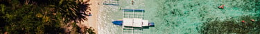 a group of boats docked at a beach