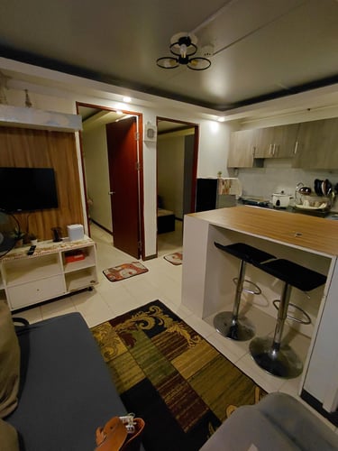 a kitchen and living room with a couch and a table