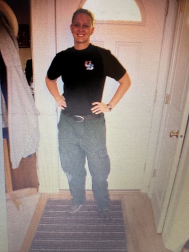 a woman standing in a doorway with her hands on her hips