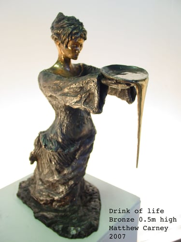 a statue of a woman holding a bowl of overflowing water