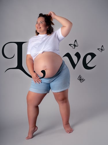 a pregnant woman in a white shirt and shorts