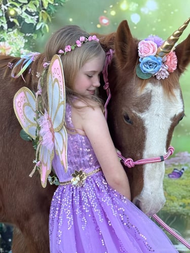 A fairy princess cuddles Snickers, the magical unicorn