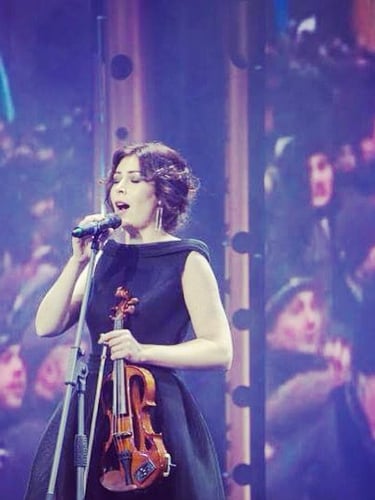Elmaz smiling in rehearsal room – cropped angle