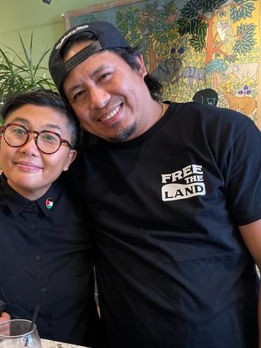 two understory collective participants standing in front of a table