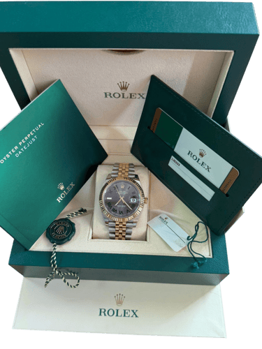 a rolex watch in a box with original receipt and certificate
