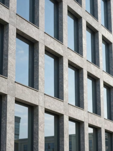 Structured architectural lines of a modern office building, large glass windows reflecting cool blue sky, sharp focus, professional depth of field