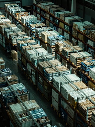 High-contrast overhead view of structured warehouse logistics, sharp geometric lines, cool crisp green-tinted lighting, deep shadows.