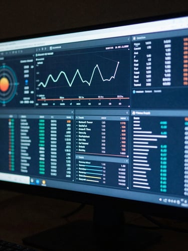 Wide shot of a high-resolution monitor displaying complex data visualizations and performance dashboards, with a cool blue screen glow and sharp shadows, moody editorial photography, 35mm film grain.