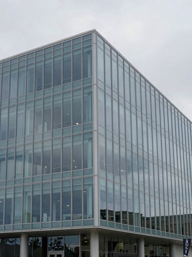 Architectural photograph of a modern glass office building in Draper Utah, soft overcast daylight, cool slate blue tones, geometric lines, 35mm