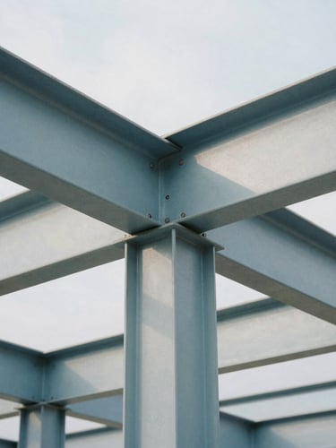 Macro architectural shot of clean geometric steel beams casting sharp shadows in diffused cool daylight, 35mm photography